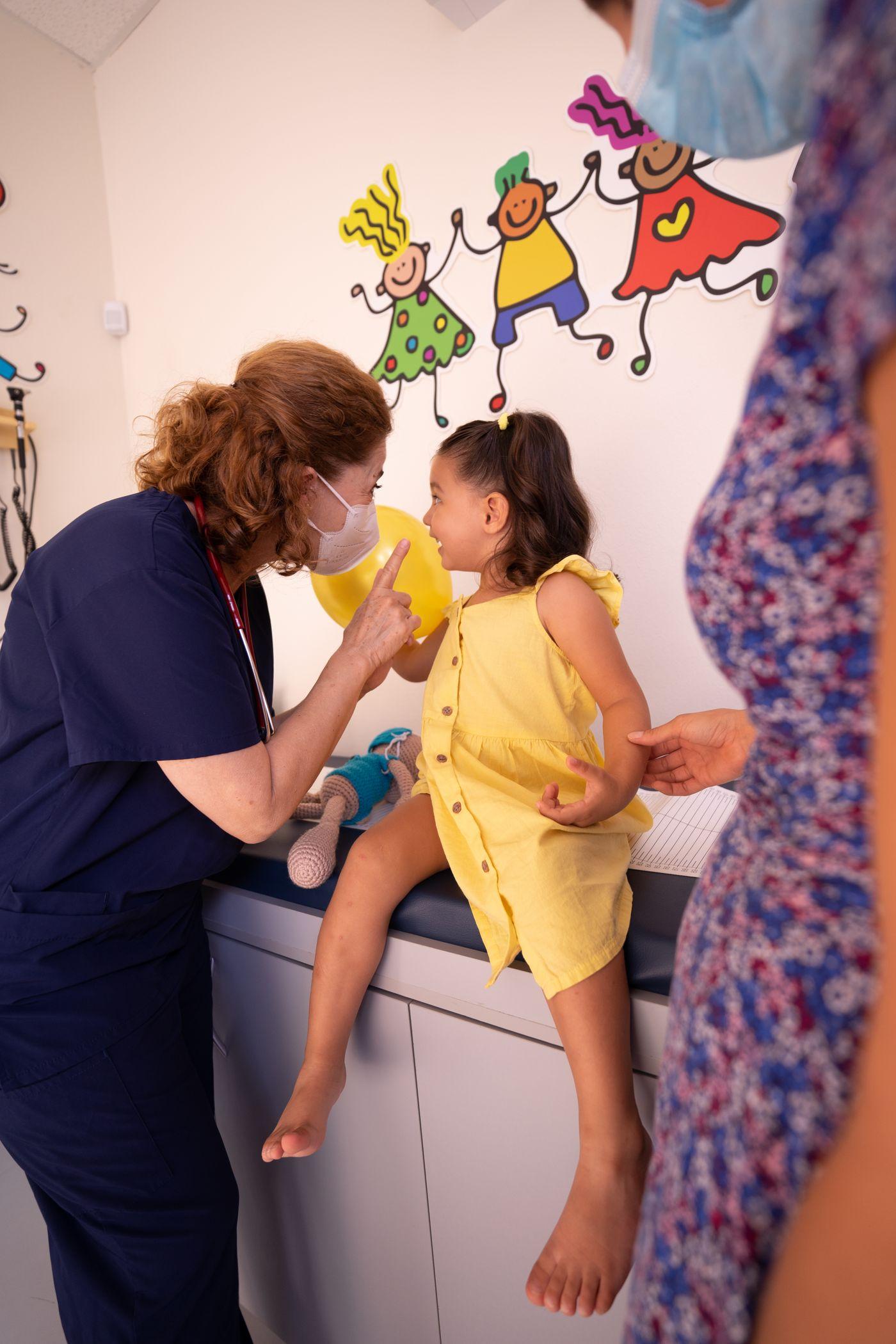 A nurse talking warmly with a child